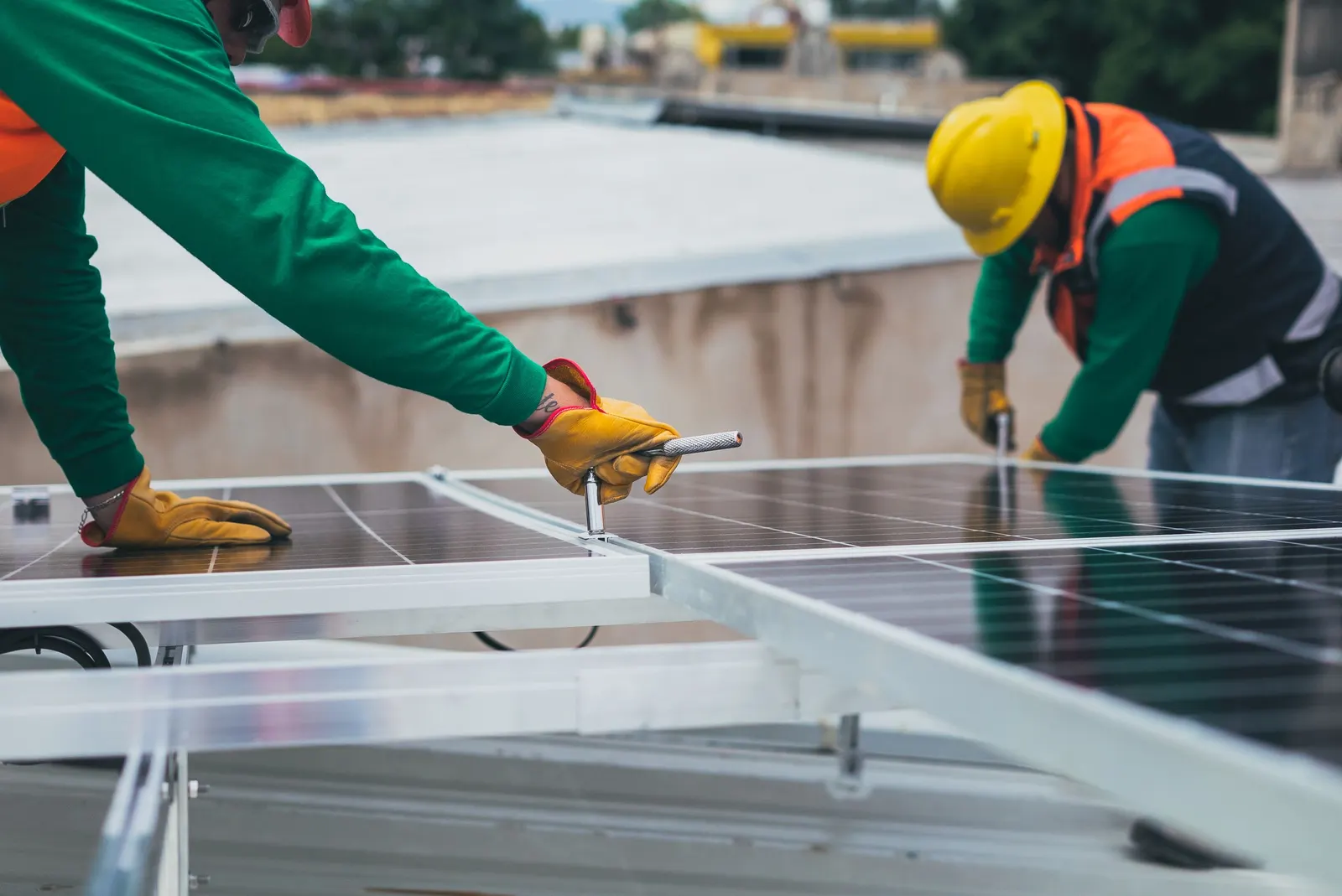 Installers fixing solar panels onto a mounting frame