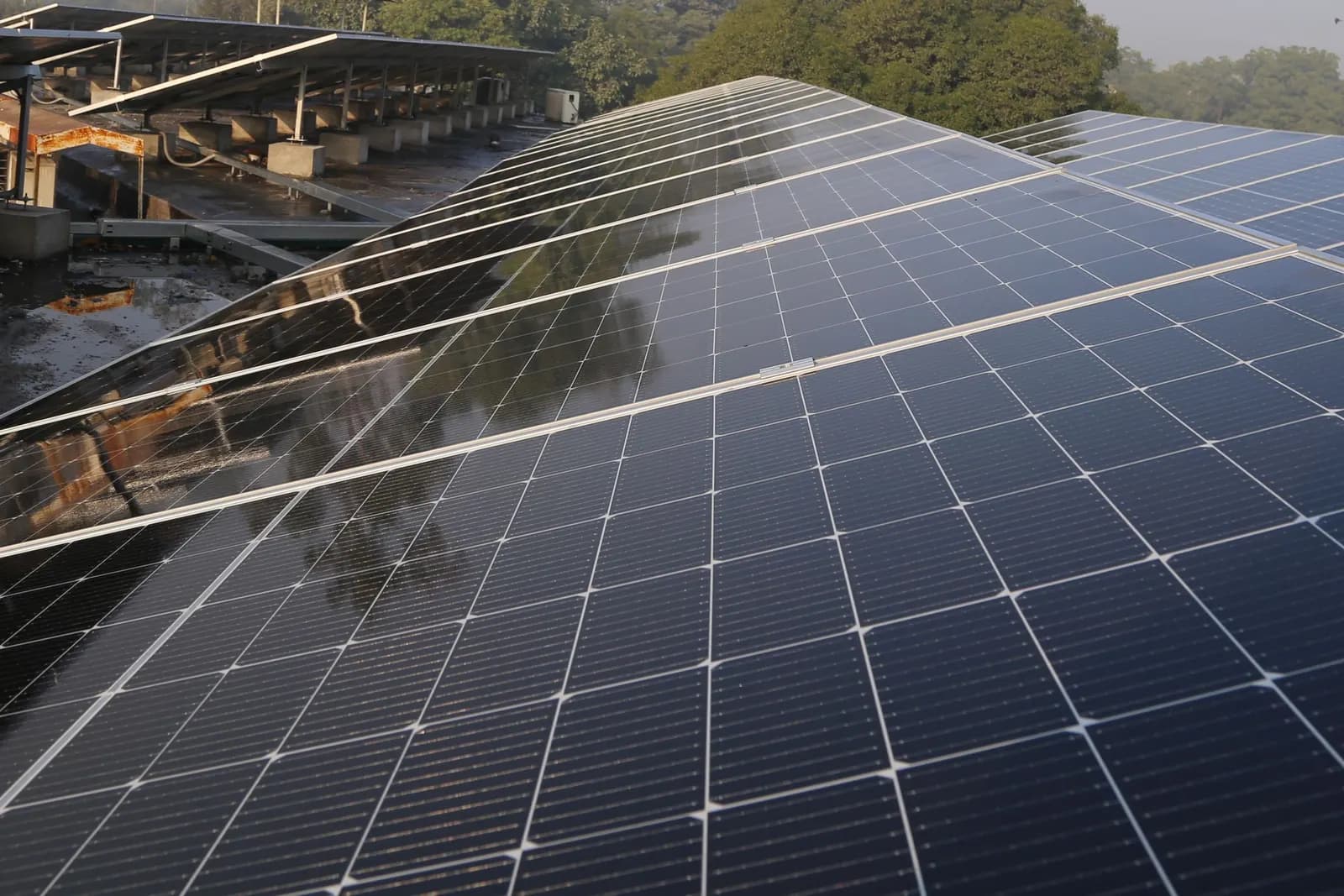 Rows of solar panels on a large rooftop